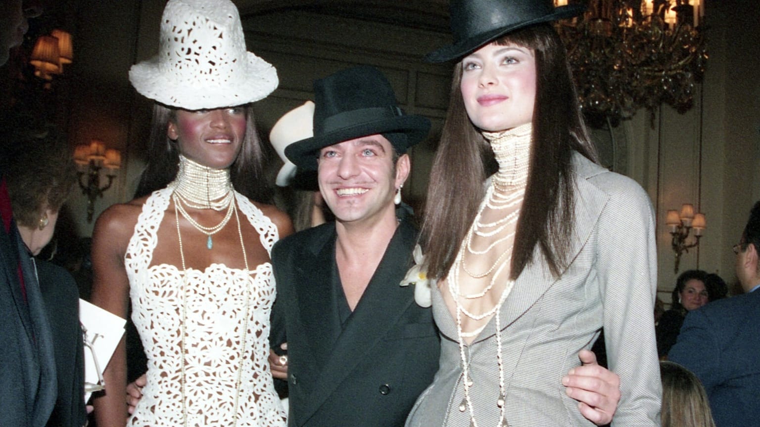FILE: John Galliano, centre, with compatriot model Naomi Campbell, left, and another unidentified model after Christian Dior's 1997 spring-summer show in Paris