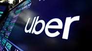 FILE - The Uber logo appears above a trading post on the floor of the New York Stock Exchange. 16 Aug. 2019