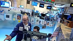 David O'Day, left, works on the floor at the New York Stock Exchange in New York. 18 March 2026. 