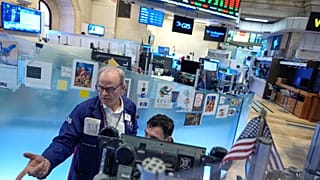 David O'Day, left, works on the floor at the New York Stock Exchange in New York. 18 March 2026. 