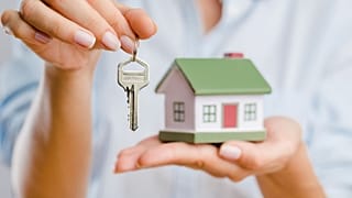 A miniature house and a house key