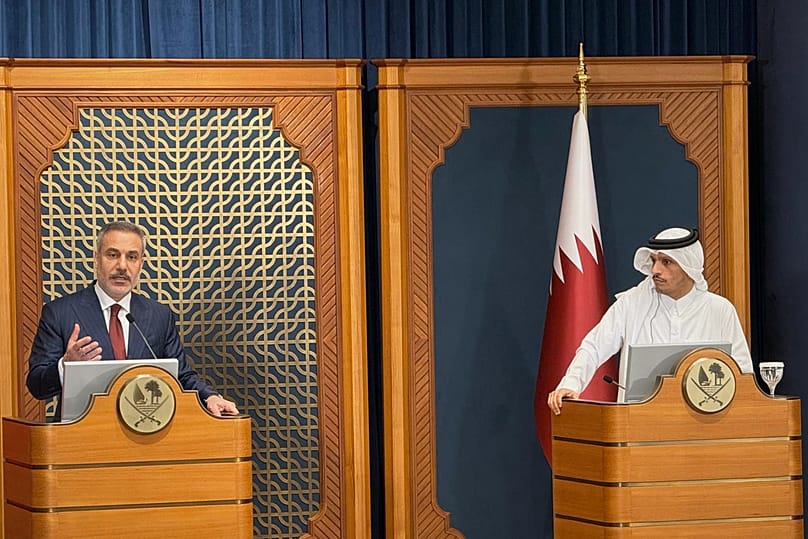 Qatar's Prime Minister Sheikh Mohammed bin Abdulrahman Al Thani, right, and Turkey's Foreign Minister Hakan Fidan, left, speak during a press conference in Doha on Thursday, M