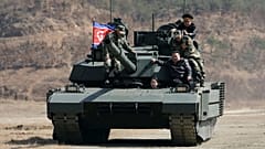Kim Jong Un, his daughter and soldiers on a tank at a military training base in North Korea, 19 March, 2026