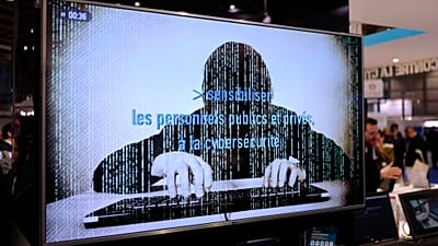 A television screen reads "Alerting public organizations and people to cybersecurity" at the International Cybersecurity forum in Lille, northern France,on Jan. 23, 2018.