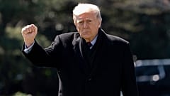 President Donald Trump pumps his fist as he walks to depart on Marine One from the South Lawn of the White House, Wednesday, March 18, 2026, in Washington.