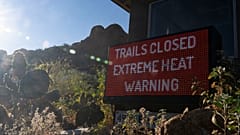 A sign warns hikers of trail closures due to extreme heat at Camelback Mountain on Thursday, March 19, 2026, in Phoenix. 