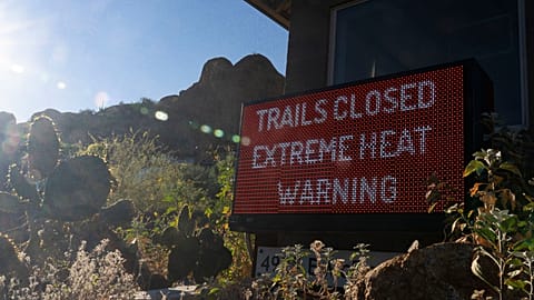 A sign warns hikers of trail closures due to extreme heat at Camelback Mountain on Thursday, March 19, 2026, in Phoenix. 