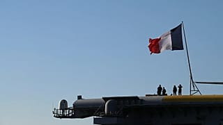 French Navy officers stand on board the aircraft carrier Charles de Gaulle off the suburb of Faliro, Athens, Thursday 24 March 2022.