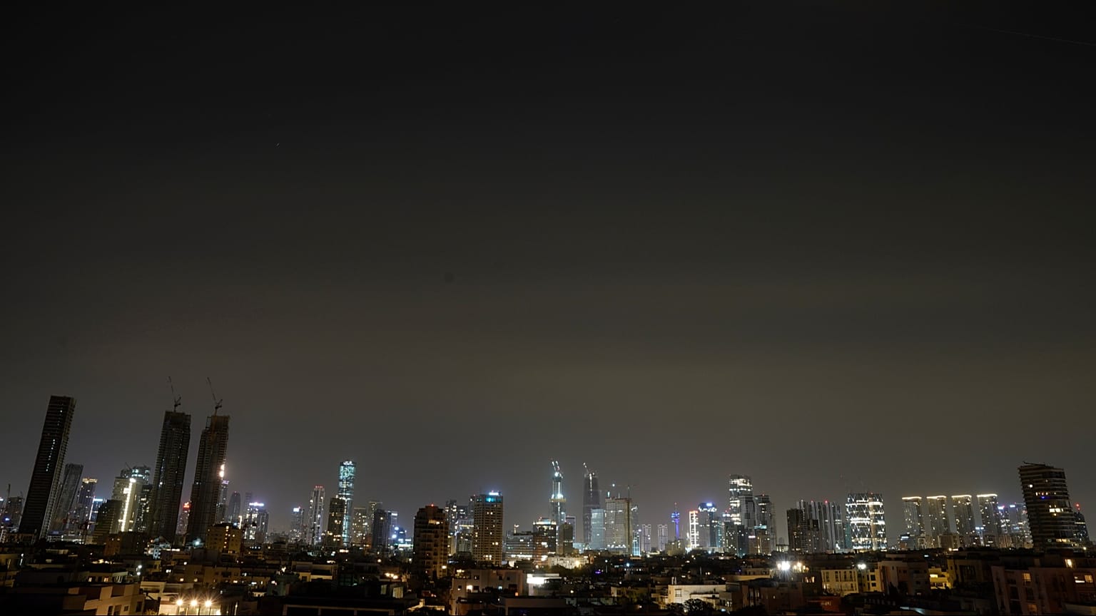 The remains of an Iranian missile cross the sky over Tel Aviv after being intercepted early Saturday, March 21, 2026. 
