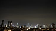 The remains of an Iranian missile cross the sky over Tel Aviv after being intercepted early Saturday, March 21, 2026. 