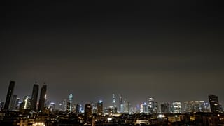 The remains of an Iranian missile cross the sky over Tel Aviv after being intercepted early Saturday, March 21, 2026. 