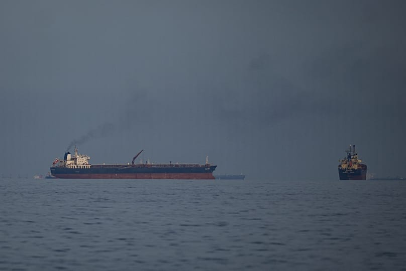 Oil tankers and cargo ships line up in the Strait of Hormuz as seen from Khor Fakkan, 11 March, 2026