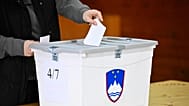 People casts her vote at a polling station for parliamentary elections in Arnace, Slovenia, on Sunday, March 22, 2026.