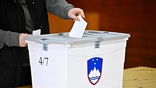 People casts her vote at a polling station for parliamentary elections in Arnace, Slovenia, on Sunday, March 22, 2026.