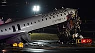 An Air Canada jet sits on the runway at LaGuardia Airport in New York after colliding with a Port Authority aircraft rescue and firefighting vehicle