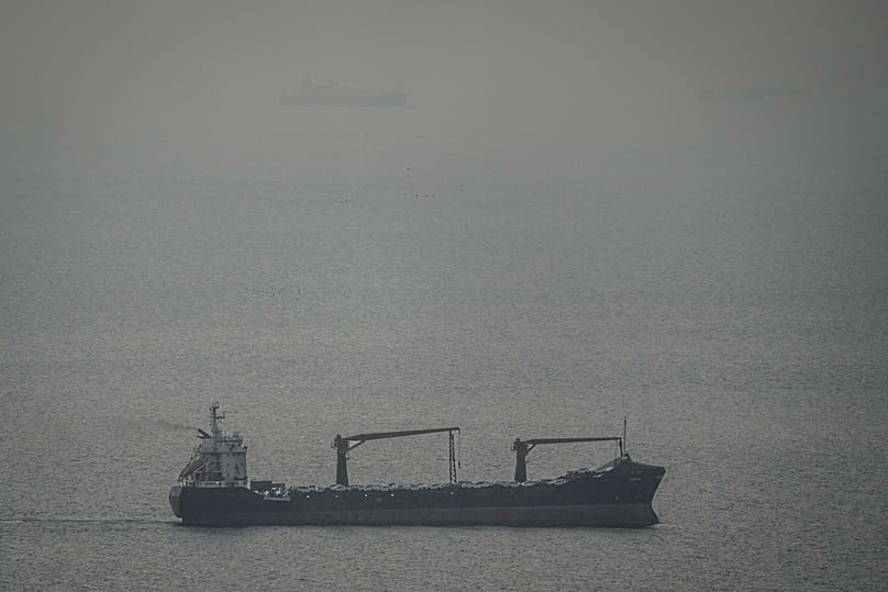 A cargo ship carrying vehicles sails through the Arabian Gulf toward the Strait of Hormuz in the United Arab Emirates, Sunday, March 22, 2026.