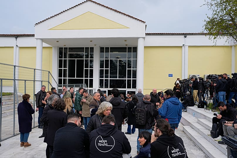 Relatives of victims of the Tempi train crash wait for the start of the trial at the court in Larissa, 23 March, 2026