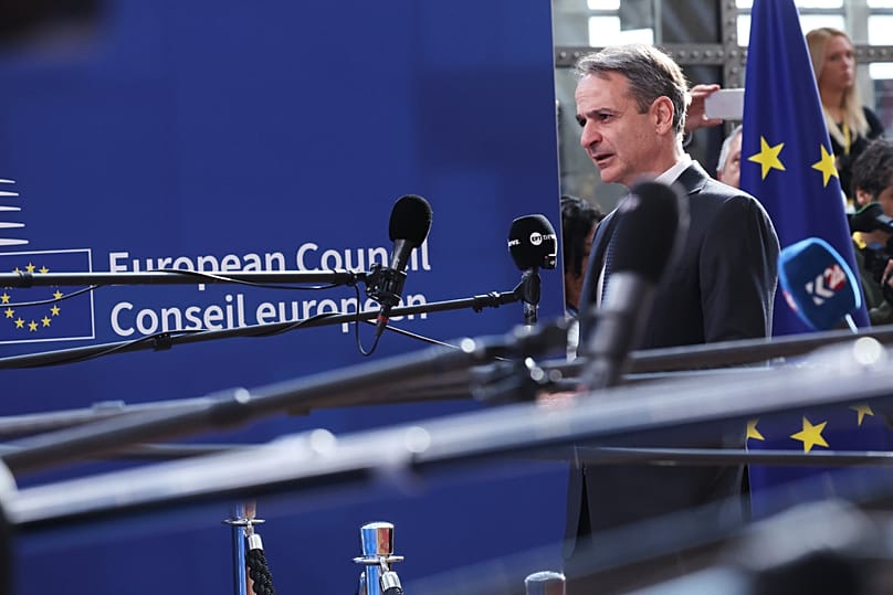 Greece's Prime Minister Kyriakos Mitsotakis speaks with the media as he arrives for the EU summit at the European Council building in Brussels, 19 March, 2026