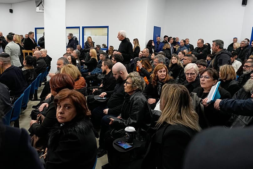 Relatives of victims of the Tempi train crash wait for the start of the trial at the court in Larissa, 23 March, 2026