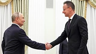 Russian President Vladimir Putin, left, and Hungarian Foreign Minister Peter Szijjarto shake hands during their meeting at the Senate Palace of the Kremlin in Moscow, Wednesda
