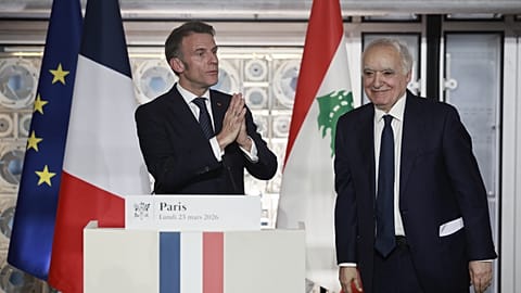 French President Emmanuel Macron, left, delivers a speech next to Lebanese Minister of Culture Ghassan Salame during his visit to the exhibition