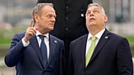 Hungary's Prime Minister Viktor Orban, right, speaks with Poland's Prime Minister Donald Tusk as they pose for a group photo during an Nuclear Energy Summit, March 2024