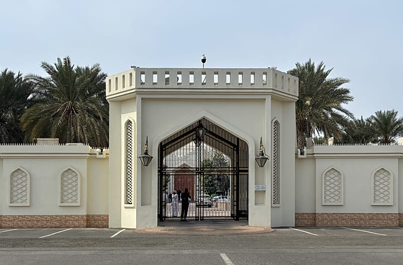 FILE: Officials are seen standing inside the gate of a palace prior to Iran-US negotiations, in Muscat, Oman, 6 February 2026