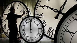 FILE: Electric Time Co. employee Walter Rodriguez cleans the face of an 84-inch Wegman clock.