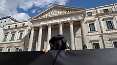 Un manifestante contrario a la eutanasia se encuentra frente al Parlamento español en Madrid, España, el jueves 18 de marzo de 2021