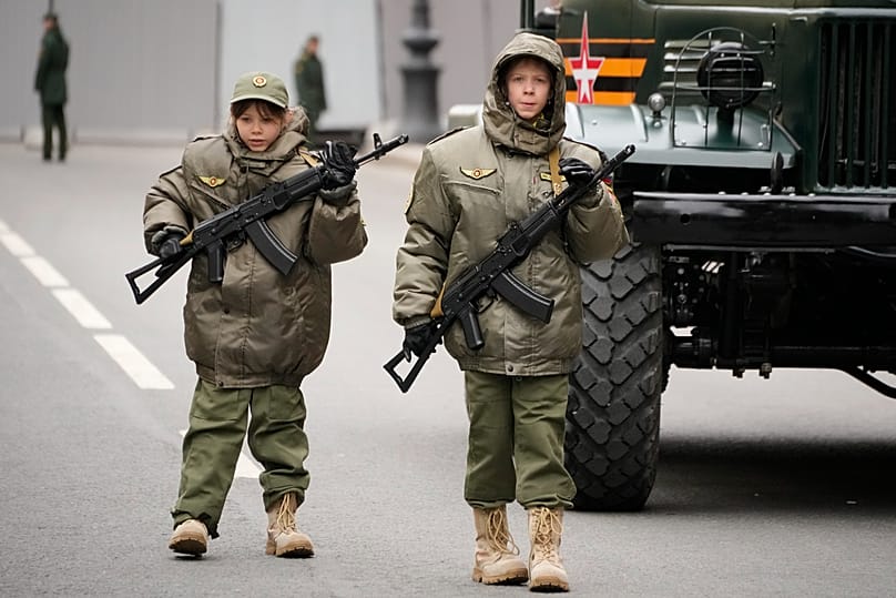 Children, participants of the parade walk, prior to a rehearsal for the Victory Day military parade at Dvortsovaya Square in St Petersburg, 5 May 2024