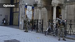 Two Belgian army soldiers patrol in front of a synagogue as part of a security deployment of soldiers outside Jewish institutions in Antwerp, Belgium, March 25, 2026