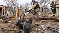 Rescue workers try to put out a fire caused by the fragments of a Russian drone that hit a private house during air attack in Kharkiv, Ukraine, Wednesday, March 25, 2026.