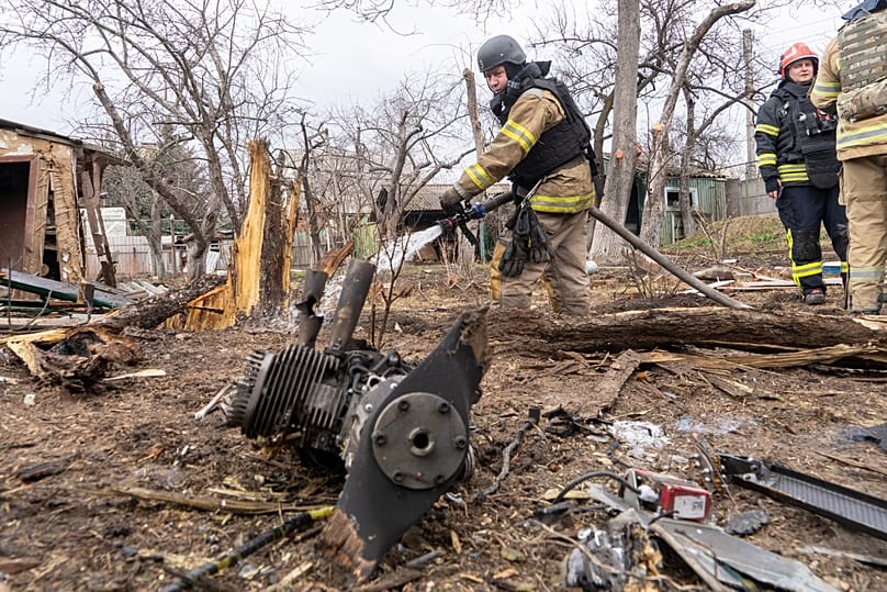 Rescue workers try to put out a fire caused by the fragments of a Russian drone that hit a private house during air attack in Kharkiv, 25 March, 2026