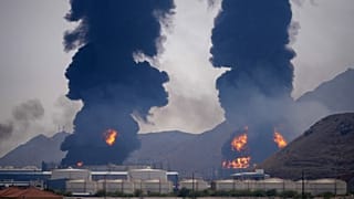 Plumes of smoke and fire rise after debris from an intercepted Iranian drone struck an oil facility, according to authorities, in Fujairah, United Arab Emirates, March 14, 202