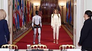 First lady Melania Trump arrives, accompanied by a robot, to attend the "Fostering the Future Together Global Coalition Summit" 