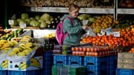 A woman selects fruits at a supermarket in London, Wednesday, Nov. 17, 2021. 