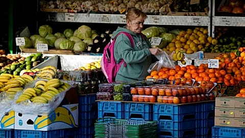 A woman selects fruits at a supermarket in London, Wednesday, Nov. 17, 2021. 