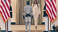 First lady Melania Trump arrives, accompanied by a robot, to attend the "Fostering the Future Together Global Coalition Summit,"