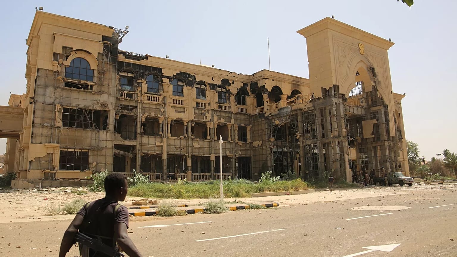 An army soldier walks in front of the Republican Palace in Khartoum, 21 March, 2025