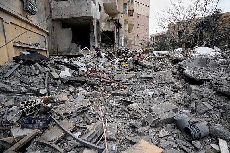 A man removes rubble as he looks for missed items from his destroyed house that was hit in an Israeli airstrike in the southern port city of Tyre, 26 March, 2026