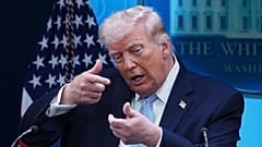 President Donald Trump pretends to aim a sniper gun while speaking with reporters in the James Brady Press Briefing Room at the White House, Monday, April 6, 2026