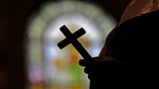 Image of a Catholic cross inside a church.