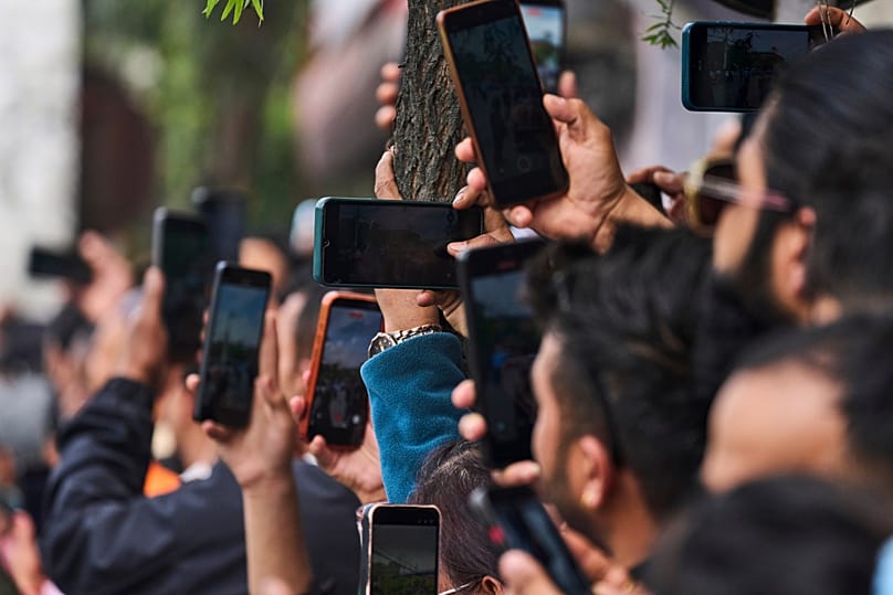 Nepalese people stand and wait to see newly elected prime minister Balendra Shah after he took the oath of office in Kathmandu, 27 March, 2026