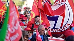 Demonstrators take part in a march organized by Italy's main labor unions, in Rome's St. John Lateran square, Saturday, Oct. 16, 2021.