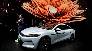 FILE - FILE - A man stands near the Han L EV model from BYD during the Shanghai auto show, April 23, 2025. (AP Photo/Ng Han Guan, File)