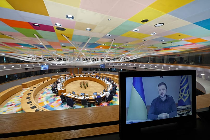Ukraine's President Volodymyr Zelenskyy speaks to EU leaders via video link during a round table meeting at the EU summit in Brussels, 19 March, 2026
