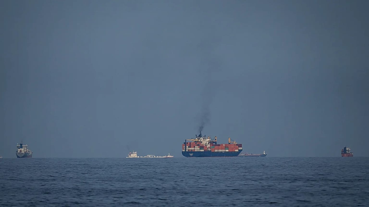 Oil tankers and cargo ships line up in the Strait of Hormuz as seen from Khor Fakkan, 11 March, 2026