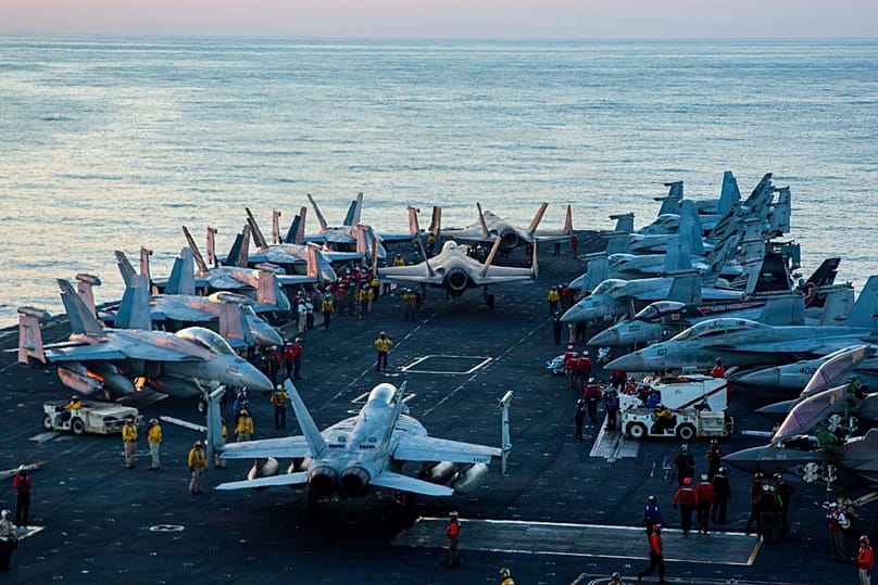 This image provided by US Central Command shows Navy sailors taxiing aircraft to a staging point on the flight deck of the USS Abraham Lincoln, Saturday, Feb. 28, 2026