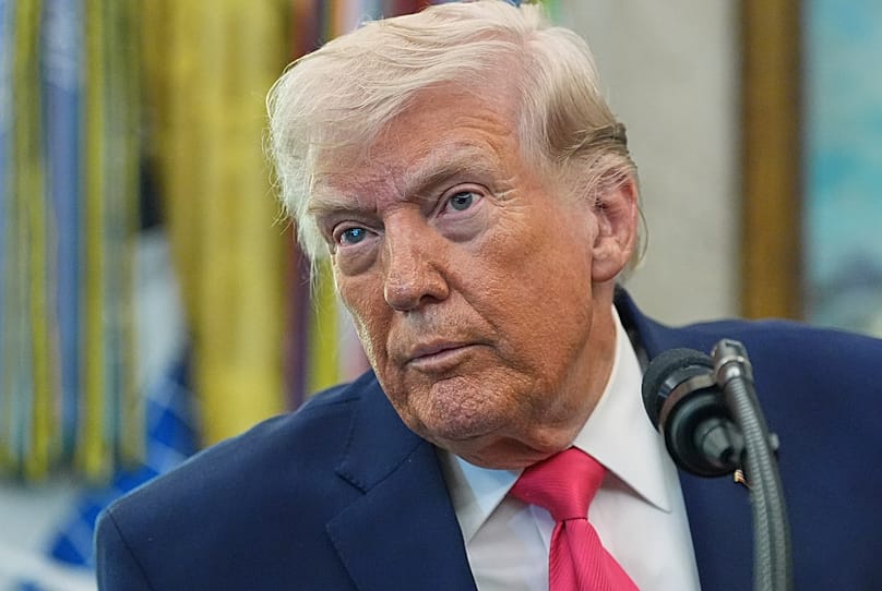Trump listens to a reporter during the swearing in for Homeland Security Secretary Markwayne Mullin in the White House, Tuesday, March 24, 2026, in Washington