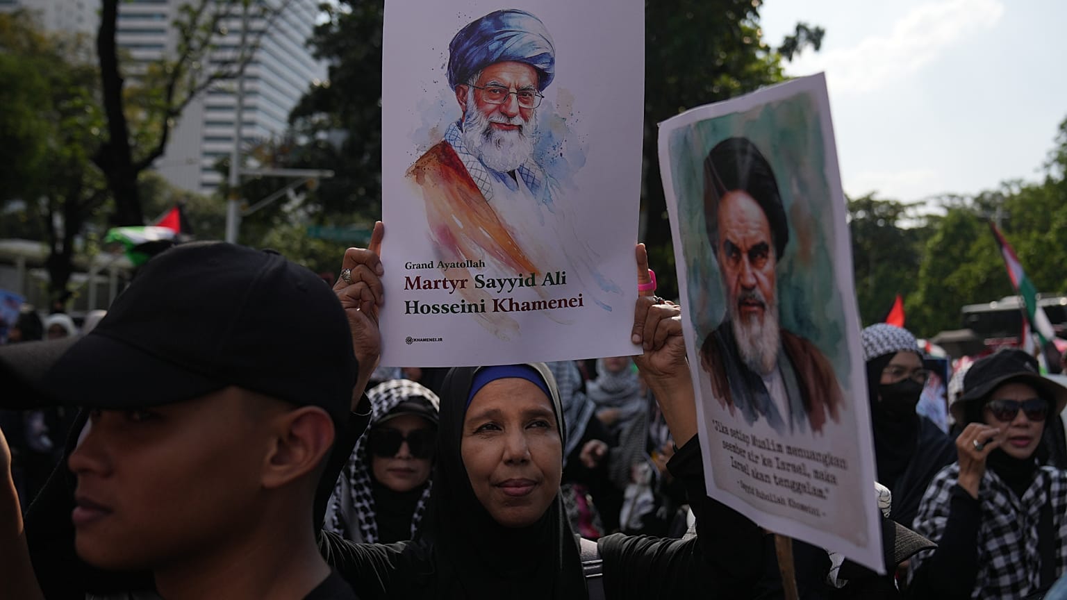 امرأة تعرض صورة المرشد الأعلى الإيراني الراحل آية الله علي خامنئي.